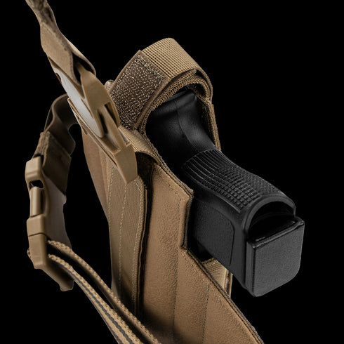 The Condor LCS RDS Leg Holster is a tan tactical holster with straps and a buckle, shown holding a black handgun. Designed for military or law enforcement use.
